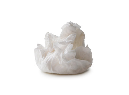 Single screwed or crumpled tissue paper or napkin in strange shape after use in toilet or restroom is isolated on white background with clipping path.の写真素材