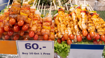 Delicious barbeque food with buy ten get one free sign is on sale at stall on street. Street foodの写真素材