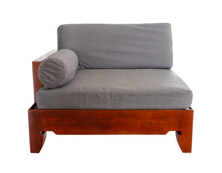 Gray quilted fabric vintage art deco style armchair on wooden base and legs is isolated on white background. Front view series of furnitureの写真素材