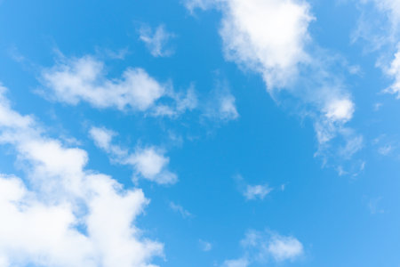 Beautiful blue sky with strange shape of clouds in the morning or evening is used as natural background texture in decorative art work.の写真素材
