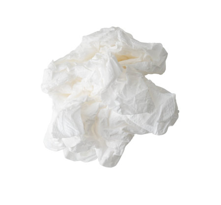 Top view of single screwed or crumpled tissue paper or napkin in strange shape after use in toilet or restroom is isolated on white background with clipping path.の写真素材