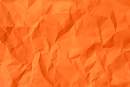 Orange crumpled paper texture is used for paper background texture in decorative art work.の写真素材