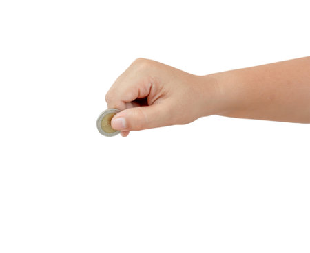 Child or kid hand is holding coin isolated on white back ground with clipping path. Concept of saving money for the future or money growthの写真素材