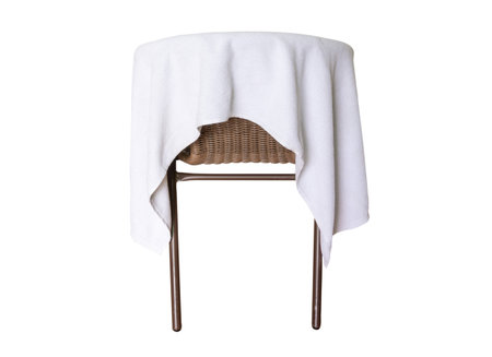 Used white towel laying on chair is isolated on white background with clipping pathの写真素材