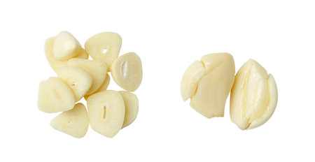 Top view set of pounded peeled garlic cloves and slices is isolated on white background with clipping path.の写真素材