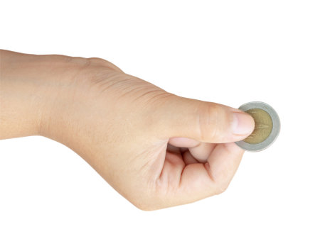 Child or kid hand is holding coin isolated on white background with clipping path. Concept of saving money for the future or money growthの写真素材