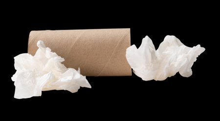 Side view of screwed or crumpled white tissue paper ball with cores or tube in stack is isolated on black background with clipping path.の写真素材