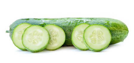 Side view of fresh green cucumber with slices in circle shape in stack is isolated on white background with clipping path.の写真素材