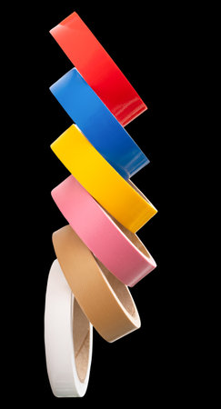 Roll set of multicolor adhesive vinyl or cloth tape is isolated on black background with clipping path.の写真素材