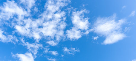 Low angle view and full frame of beautiful blue sky with strange shape of fluffy white clouds in the morning or afternoon in sunny day is used as natural background texture in decorative art work.の写真素材