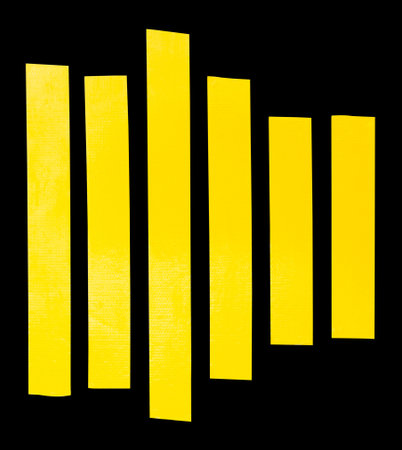 Top view set of tidy straight yellow adhesive vinyl tape or cloth tape in stripe shape is isolated on black background with clipping path.の写真素材