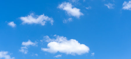 Low angle view and full frame of beautiful blue sky with strange shape of fluffy white clouds in the...
