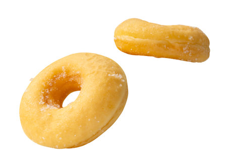 Top view set of two pieces of scattering cinnamon donuts is isolated on white background with clipping path.の写真素材