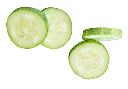 Top view set of fresh green cucumber slices in circle shape in stack is isolated on white background with clipping path.の写真素材
