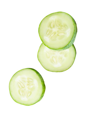 Top view set of fresh green cucumber slices in circle shape in stack is isolated on white background with clipping path.の写真素材