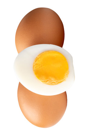 Top view of raw chicken eggs and peeled cooked or boiled egg with egg yolk in half is isolated on white background with clipping path.の写真素材
