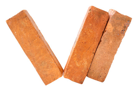 Side view of three cracked old red or orange bricks in stack is isolated on white background with clipping path.の写真素材
