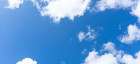 Low angle view of beautiful blue sky with strange shape of fluffy white clouds in the morning or evening in sunny day is used as natural background texture in decorative art work.の写真素材