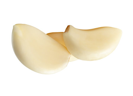 Side view of three white peeled garlic cloves or pieces in stack is isolated on white background with clipping path.の写真素材