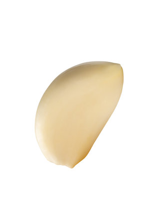 Single peeled white garlic clove is isolated on white background with clipping path.の写真素材