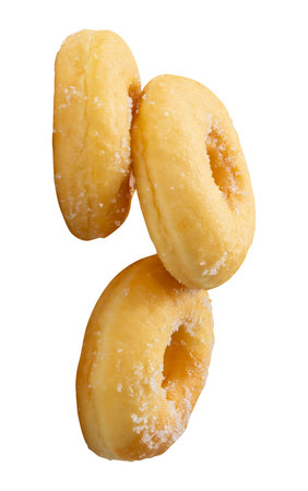 Side view of three brown sugar glazed cinnamon donuts in stack is isolated on white background with clipping path.の写真素材