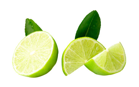 Front view set of one green lemon half and two quarters with green lemon leaves in stack are...