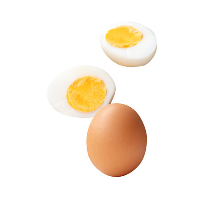 Top view set of raw brown chicken egg and cooked or boiled chicken egg with egg yolk in two halves...