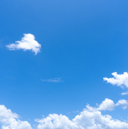 Low angle view and full frame of beautiful blue sky with strange shape of fluffy white clouds in the...