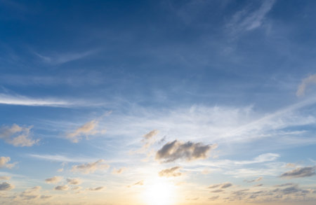 Beautiful morning or evening blue and orange sky with cloudy while sunsets or sunrises was taken at the sea used as natural background textureの写真素材