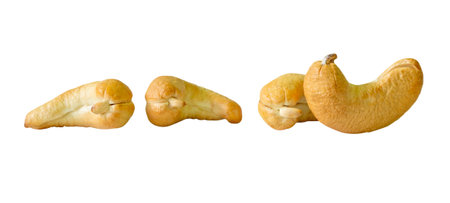 Side view set of four roasted or baked cashew nuts is isolated on white background with clipping path.の写真素材