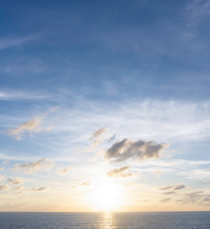 Beautiful morning or evening blue and orange sky with cloudy while sunsets or sunrises was taken at the sea used as natural background textureの写真素材