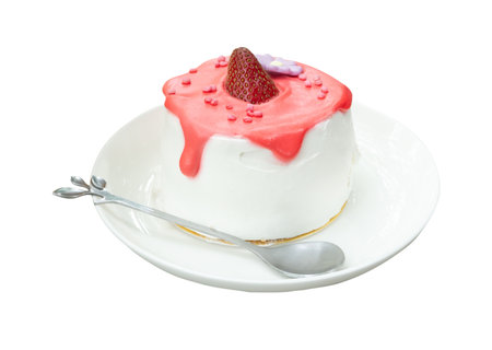 Strawberry cake with glazed cream in mini white plate with mini silver spoon or tea spoon is isolated on white background with clipping path.の写真素材