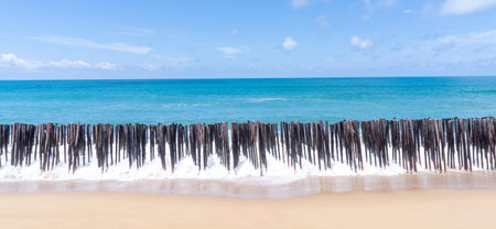 Deep blue sea with whitecap of wave into the coast and blue sky whit thin fluffy clouds in the...