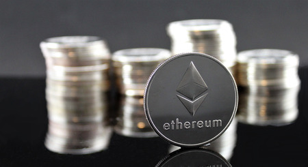 Ethereum ETH & Ripple XRP coins with cryptocurrency stacks in the backgroundのeditorial素材