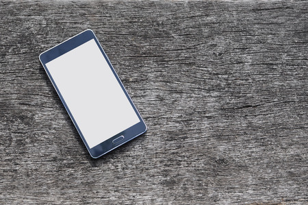 Smartphone on wood background with copy spaceの写真素材