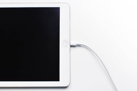 Tablet Charging isolated on white backgroundの写真素材