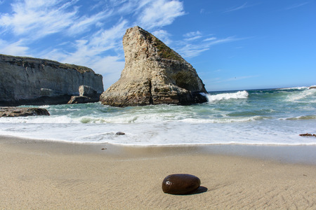 Santa Cruz Shark Fin Cove with Stone on Beach, Under Blue Skyの写真素材