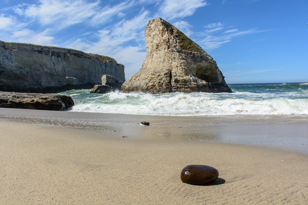Santa Cruz Shark Fin Cove with Stone on Beach, Under Blue Skyの写真素材