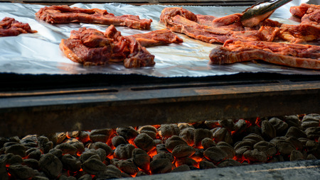Barbequing Ribs on Charcoal Fire in the Summer.の写真素材