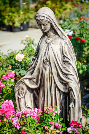 Mary Statue in the Garden with Flowersの写真素材