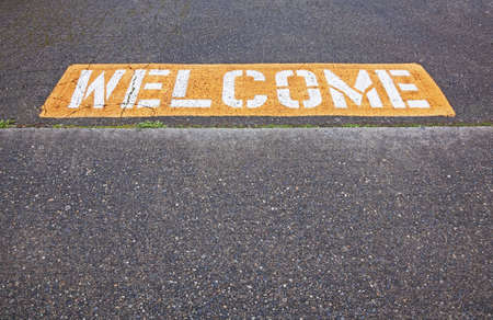 weclome sign at entrance to parking lotの写真素材