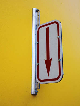 arrow sign on wall marking parking entranceの写真素材
