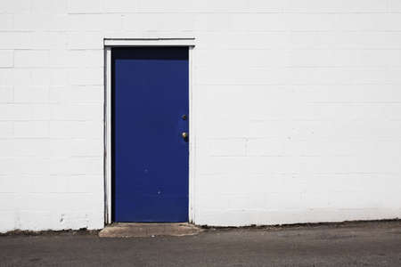 deep blue door on white buildingの写真素材