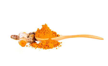 Turmeric and Turmeric powder in spoon  on white backgroundの写真素材