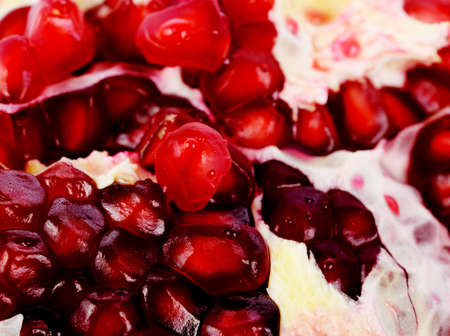 Close Up Pomegranate fruit seeds on white backgroundの写真素材