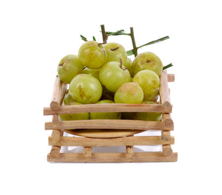 Indian gooseberry in bamboo basket isolated on white backgroundの写真素材
