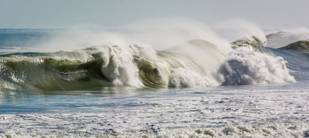 Stormy seas scene with breaking waves crashing on beach
