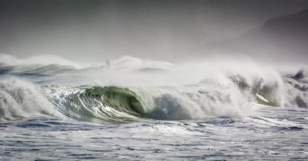 Stormy seas scene with breaking waves crashing on beachの写真素材