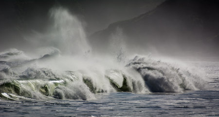 Stormy seas scene with breaking waves crashing on beach