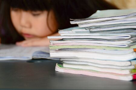 Little girl tired of doing homeworkの写真素材